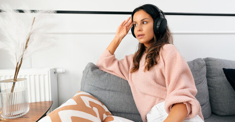 Woman relaxing, listening music at home