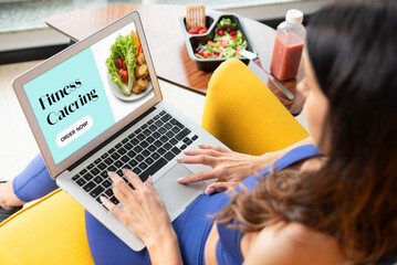 Fit woman eating healthy food at home.
