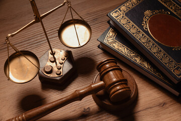 Judge gavel and weight scale on wooden table