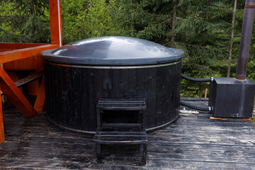 Beautifully Designed Wooden Hot Tub Perfect for Relaxation and Enjoyment Amongst Nature's Beauty and Breathtaking Scenery in a Peaceful Forest Setting
