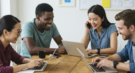 Diverse group collaborating on laptops in a modern office setting.  Four people working together