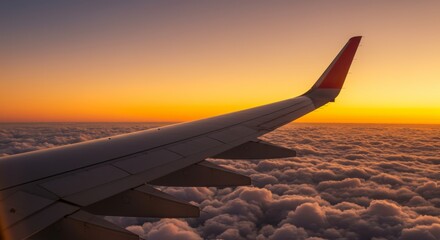 Obraz premium Aerial View from Airplane Window showcasing Airplane Wing Above the Clouds at Sunset