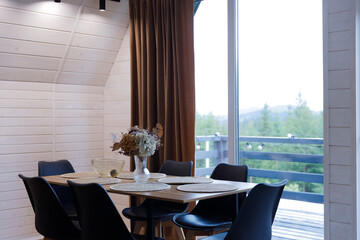 Stylishly Designed Dining Space Featuring a Cozy Table Surrounded by Elegant Chairs and Beautiful Decor, Perfect for Creating Memorable Moments with Loved Ones