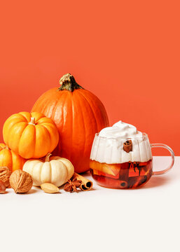 Spicy pumpkin cider drink and pumpkins