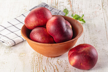 Ripe sweet juicy flat nectarines heap