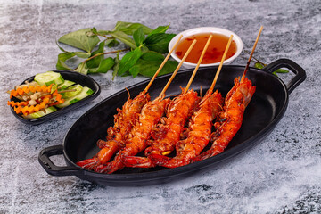 Grilled prawn skewer served sauce