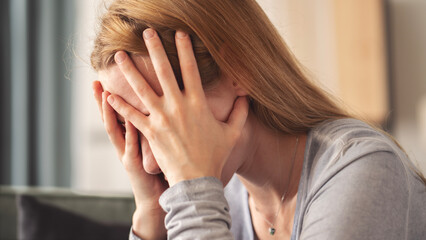 Young woman holding her head with her hands