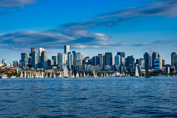 2025-06-03 VIEW OF THE SEATTLE SKYLINE FROM SOUTH LAKE UNION DURING A LOCAL SAILING RACE WITH CALM WATERS AND A NICE LIGHT BLUE SKY WITH CLOUDS