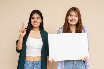 two young women holding blank board