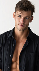 Obraz premium A handsome man , blue eyes wearing black shirt, white background.