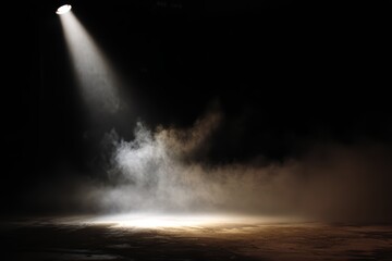 Spotlight beam illuminates stage with smoke and dark atmosphere, anticipating performance or event.