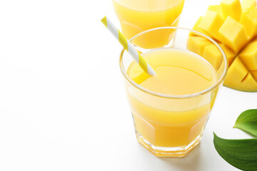 Tasty mango juice in glasses, fresh fruit and green leaves on white background, closeup. Space for text