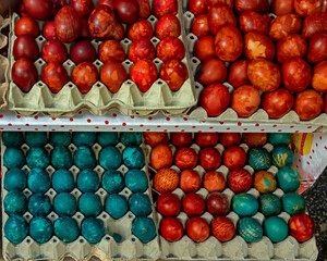 Colorful cooked and coloured Easter eggs outside on a market
