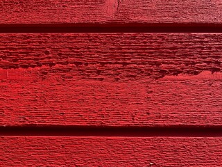 a red painted washed out plank wall