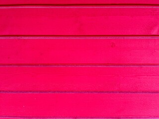 a red painted washed out plank wall