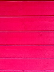 a red painted washed out plank wall
