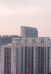 Fototapeta premium Aerial view of Gurgaon,Haryana,India.Colorful sunset in Gurugram city urban skyline with luxury residential apartments,commercial buildings.Modern architecture in premium business hub,Delhi NCR.