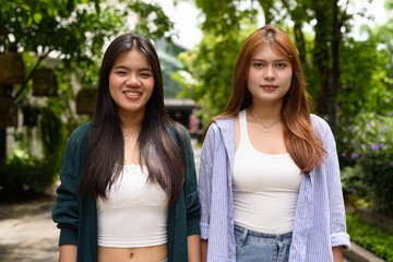Portrait of two young women smiling outdoors