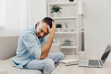 Fototapeta premium A contemplative man experiencing AI anxiety while engaging in digital detox at home, blending work and personal life, reflecting on his mental health journey.