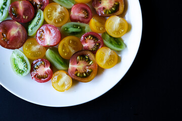 Selection of Small Sweet Colourful Sliced Raw Ripe Summer Tomatoes
