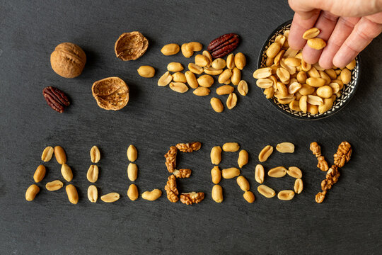 Nut allergy. The word ALLERGY is made up of various nuts. The concept of health. Immune system reaction, anaphylactic shock. Peanuts, Allergy symptoms and diagnosis. copy space, close up, flat lay