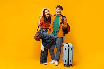Overjoyed couple with passport and tickets, both gesturing yes, ready for vacation, filled with joy...