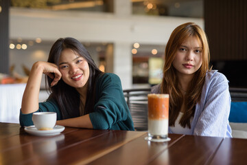 two women drinking coffee in cafe