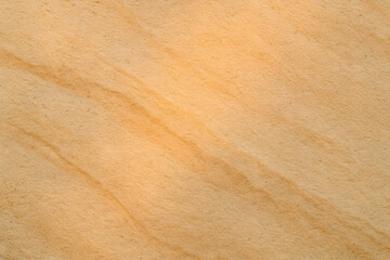 Macro image of light golden sandy texture with soft lines and natural granular pattern, perfect for backgrounds..
