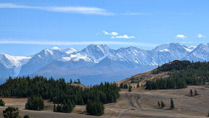 Winding road through Kuray Steppe with North Chuya Range in background, Altai, Russia