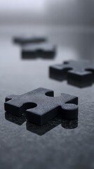 Black puzzle pieces on dark reflective surface teamwork concept