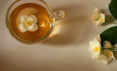 Tea with jasmine flowers in glass cup top view