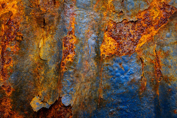 Rusty metal surface with shabby background paint. Blue cracked paint texture on an iron sheet. Fragment of an old metal door, Metal corrosion.