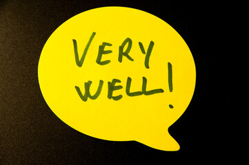 Photograph of a yellow emoji on a black background with " well done!" written inside.