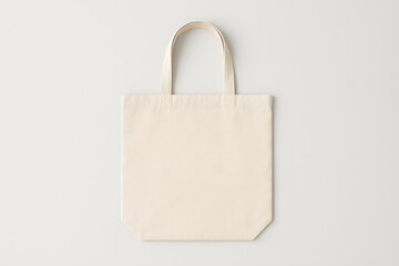 Blank beige cotton tote bag mockup on light gray background