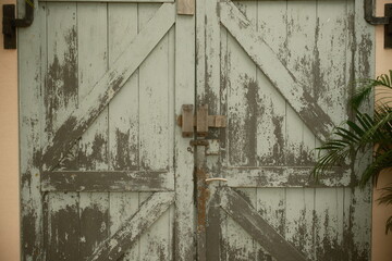 weathered wooden barn double door with a sturdy locking mechanism