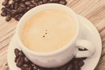  Coffee in cup and roasted dark coffee beans © ratmaner