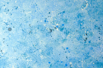 Vibrant blue abstract artwork featuring splashes and textures on canvas