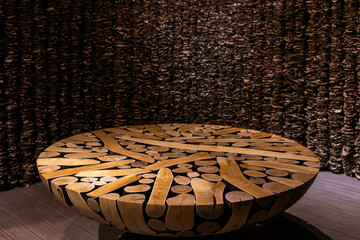 table composed of tree trunks, and curtain composed of dried leaves in the art museum