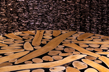 table composed of tree trunks, and curtain composed of dried leaves in the art museum