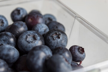 Blueberries in a plastic bow bought from the market.