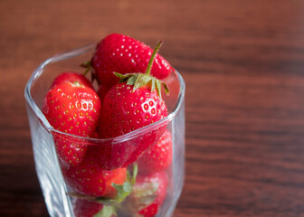Glass cup full of strawberries.