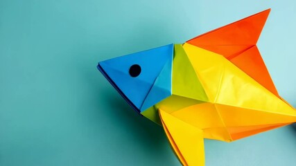Vivid Origami Fish on Turquoise Background, Decorative Paper Craft, Geometric Design, Vibrant Colors, Contemporary Art, and Flat Lay Composition - Powered by Adobe