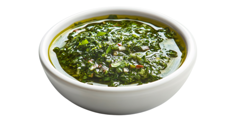 Fresh homemade chimichurri sauce in a white bowl, vibrant green Argentinian condiment with herbs and olive oil Concept of healthy eating, gourmet cuisine, and culinary arts