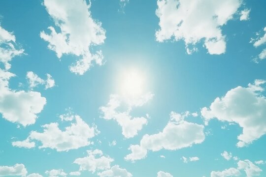 Wispy clouds drift across a bright blue sky under the warm sun during a clear day, Clouds moving in the blue sky during bright sunny summer day