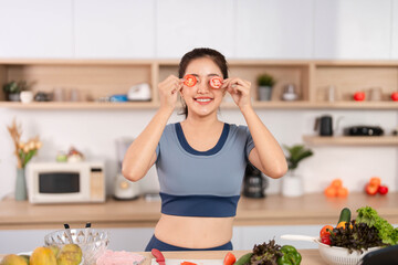 ESG and Healthy Lifestyle. Woman playfully holding tomato slices in front of her eyes.