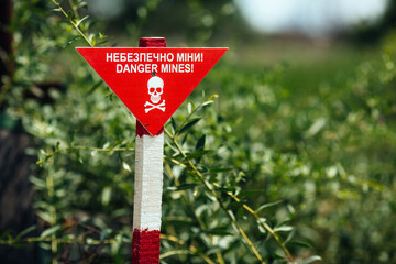 War in Ukraine mined destroyed village Kamyanka. Izyum district summer 2025. red sign danger mines
