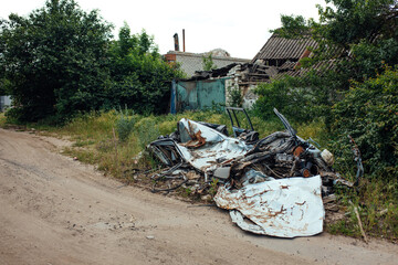 War in Ukraine mined destroyed village Kamyanka. Izyum district summer 2025. the car was run over by a tank