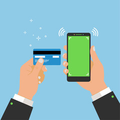 A hand holds a card near a phone a transaction being processed