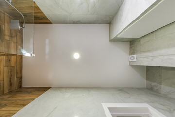 suspended ceiling with halogen spots lamps and drywall construction in empty room. Stretch ceiling...