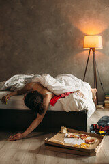 Young woman sleeping after party at home with messy room